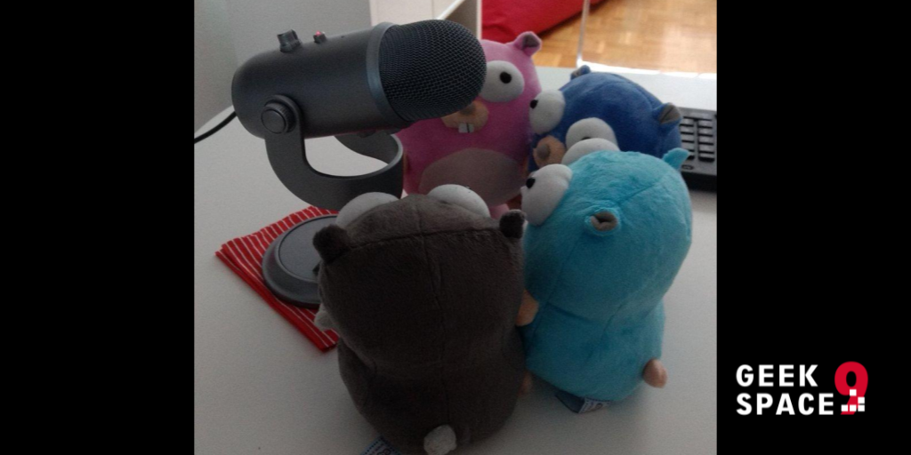 4 gophers (stuffed animals) standing around a microphone